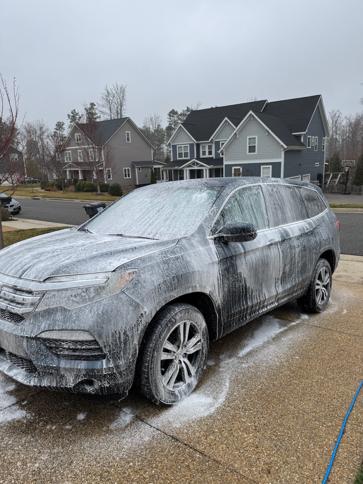SUV under a foam-cannon wash by Dagger Shine