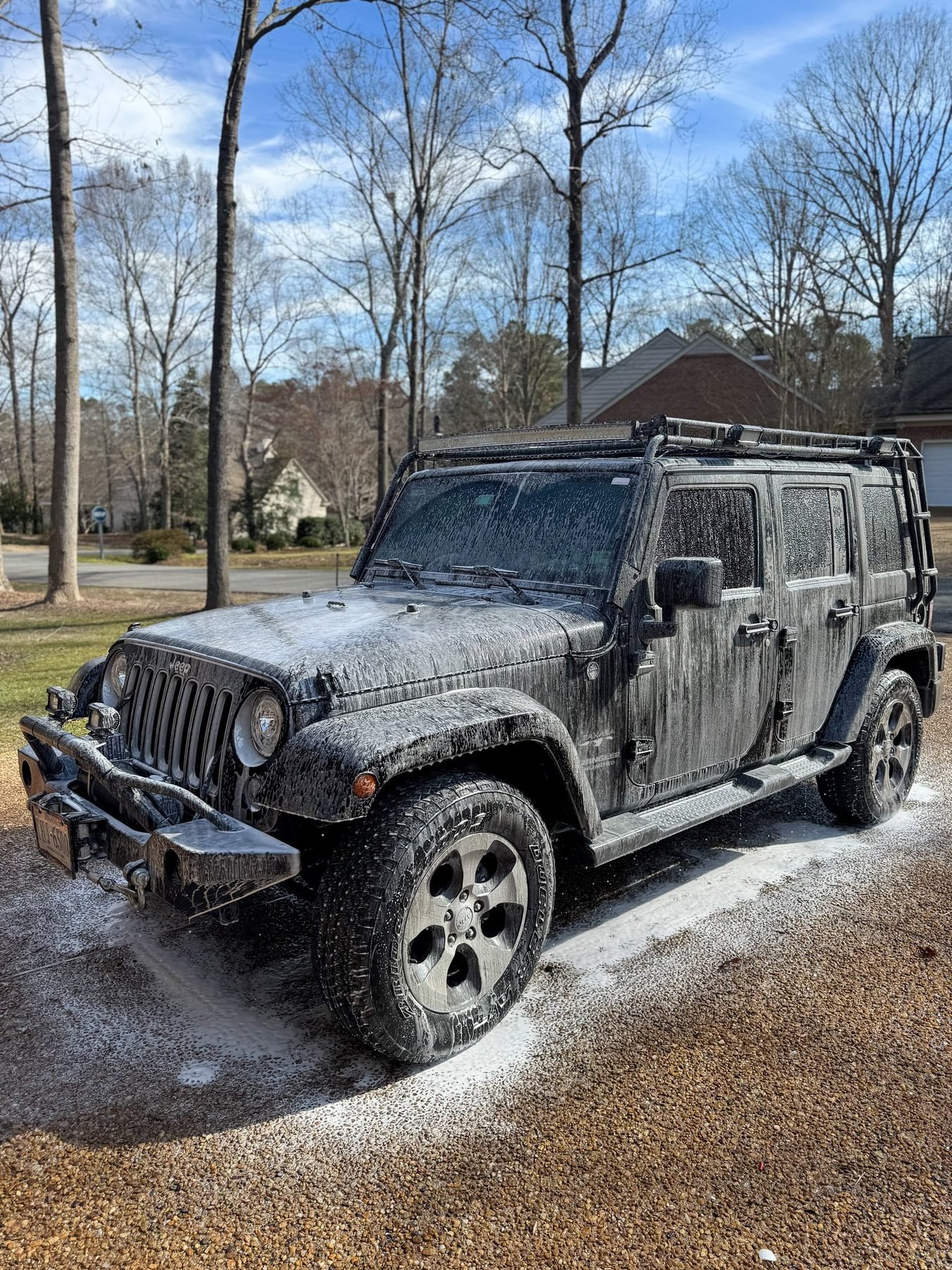 Black Jeep Wrangler covered in foam-cannon wash by Dagger Shine